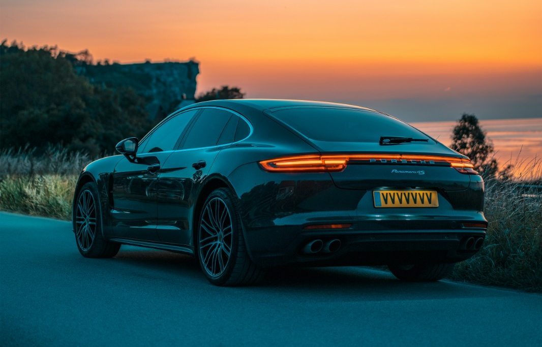 A sleek Porsche 911 parked by the roadside, ready for an exhilarating drive.